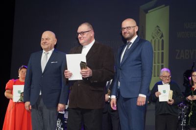 Ksiądz Proboszcz Jarosław Szeląg odbiera statuetkę i dyplom.
